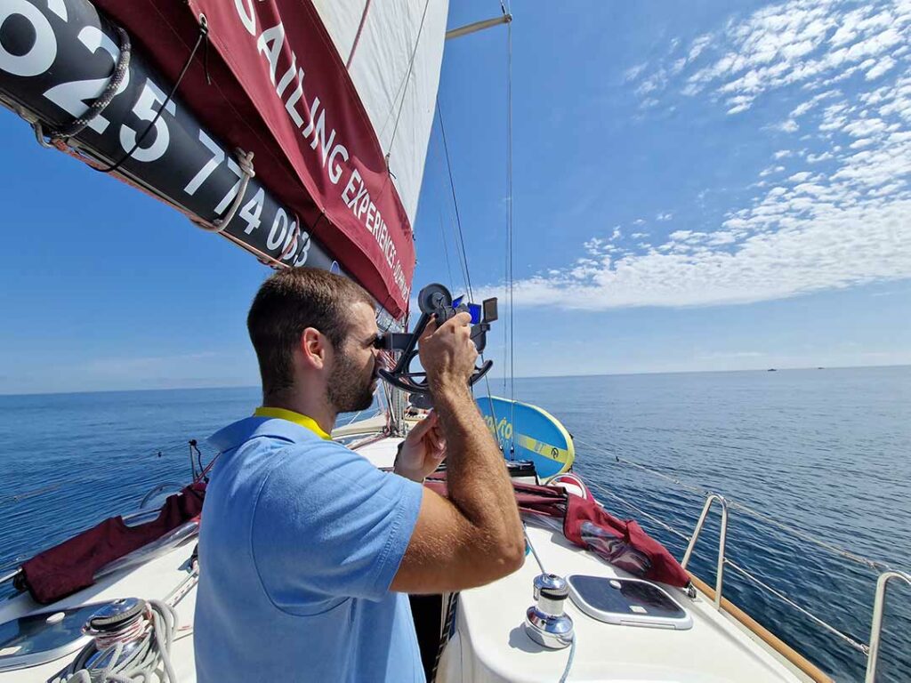 Man taking pictures on a boat during Strait of Gibraltar Sailing Trip From Estepona