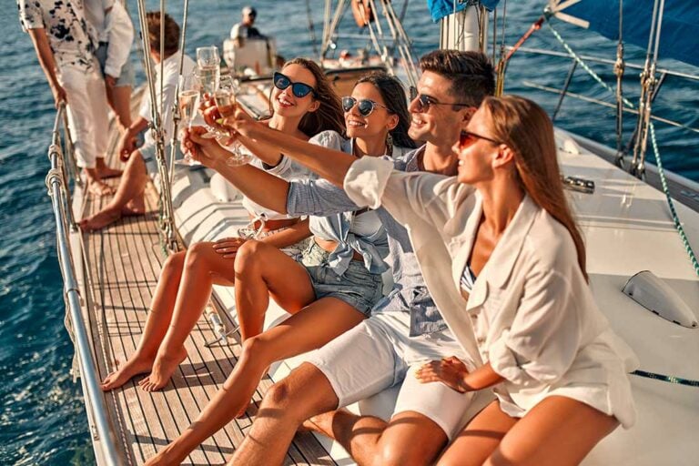 Young people enjoying champagne onboard our boat in Estepona.