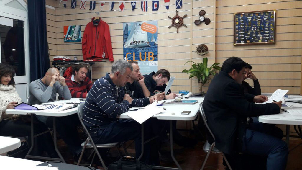 prospective sailors at their desks taking the pnb exam in Estepona